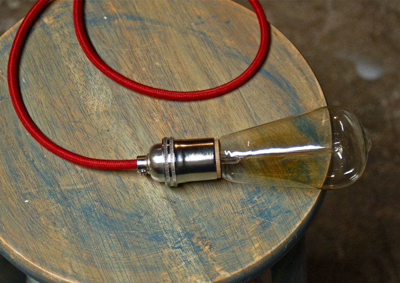 May include: A red electrical cord with a chrome light bulb socket and a clear glass light bulb.