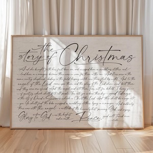 May include: A white wooden sign with black text that reads "The story of Christmas". The text is a passage from the Bible about the birth of Jesus.