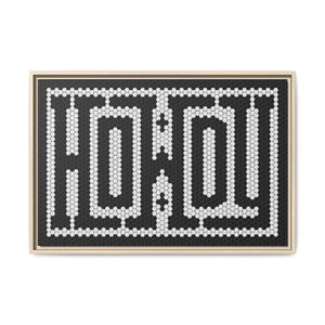 May include: Geometric wall art displaying the word "HOHO" in a black and white hexagonal tile design. The artwork is framed in a light wood-tone frame, offering a modern and minimalist aesthetic.