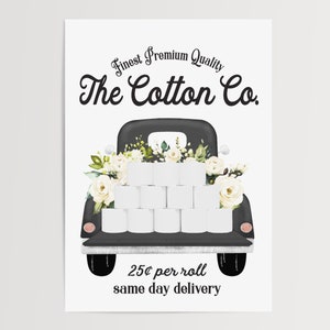 May include: A black vintage truck with white flowers and a full bed of toilet paper rolls. The truck has a sign that reads "Finest Premium Quality The Cotton Co. 25&cent; per roll same day delivery".