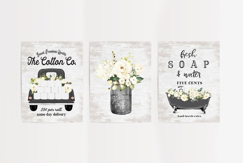May include: Three vintage-style prints with a farmhouse theme. The first print features a black pickup truck with white flowers and toilet paper rolls. The second print features a mason jar with white flowers. The third print features a black bathtub with white flowers and the text "fresh SOAP & water FIVE CENTS hand towels extra".