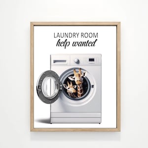 May include: A white washing machine with a sign that says "Laundry Room Help Wanted". Two giraffes are peeking out of the washing machine door.