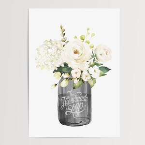 May include: A watercolor painting of a white flower bouquet in a gray mason jar. The jar has the text "The Handmade Soap Co." on it.