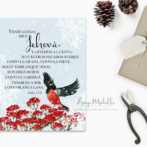 May include: A print with Spanish text and a bird illustration. The text is in black script on a light blue background with snowflakes. A wrapped gift, pine cones, and scissors are also visible.