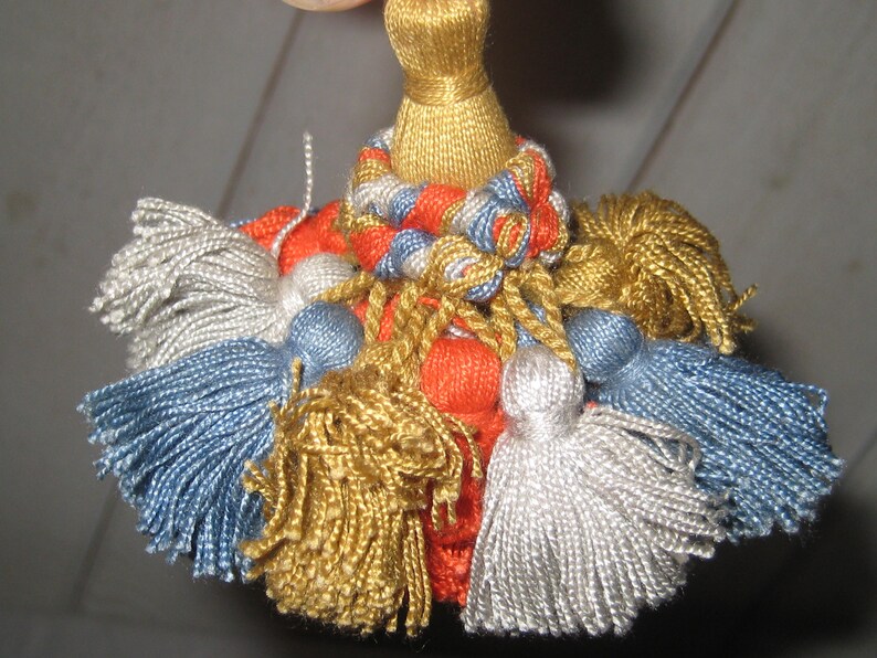 vintage orange old clock key gold tassel blue gray Skeleton key on ornate tassle antique