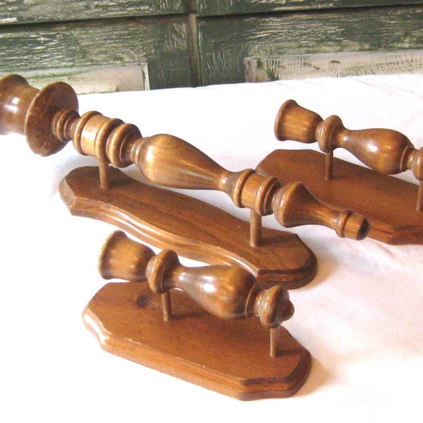 Vintage trio of brown wood wall candlestick holders, turned wood finials, three decorative wooden taper candle holders, mid century 60s 70s