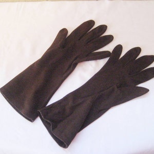 May include: A pair of long brown gloves made of a soft fabric.