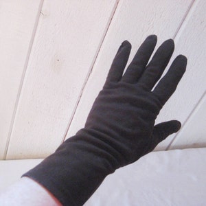 May include: A pair of long black gloves made of a soft, stretchy fabric.