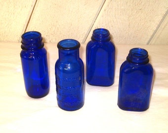 Vintage collection of four cobalt blue glass bottles, dark navy blue jars, instant collection small vases, Milk of Magnesia Bromo Seltzer