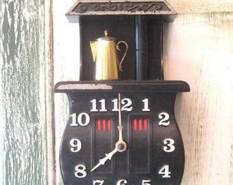 Vintage black pot belly stove wall clock, mid century 1960s made in USA, kitchen electric wall clock old time numbers, Spartus Corporation