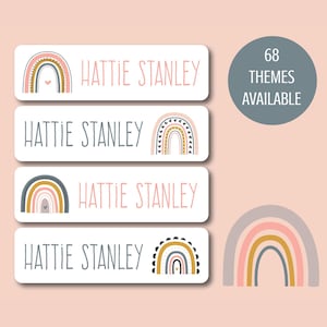 May include: Four white rectangular labels with the name "Hattie Stanley" and a rainbow design in pink, yellow, and gray. The labels are for personalizing items. 68 themes are available.