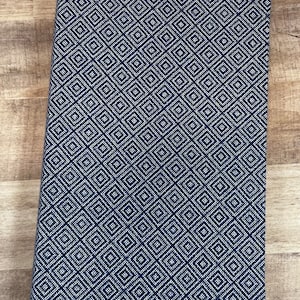 May include: A navy blue notebook with a white geometric pattern. The notebook has a soft, textured cover.