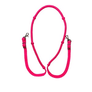 May include: Pink braided leather horse reins with silver buckles.