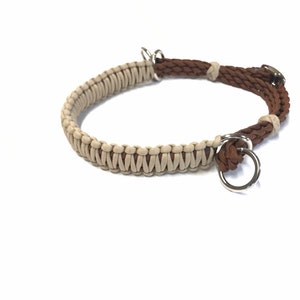 May include: A brown and beige braided dog collar with two silver metal rings.