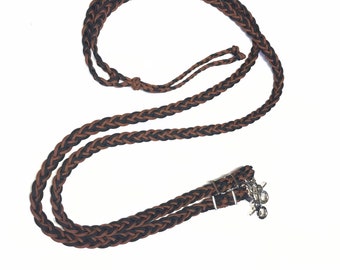 May include: A brown and black braided leather rein with silver snap hooks.