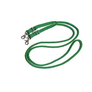 May include: Green braided leather reins with silver snap hooks. The reins are braided with a diamond pattern.