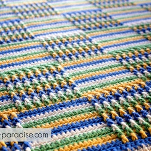 May include: A crocheted blanket with a checkered pattern in blue, green, white, and yellow.