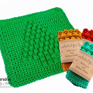 May include: Three crocheted dishcloths in green, orange, and red with a brown tag that reads "Crocheted for You with Love and Holiday Wishes".