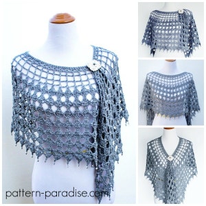 May include: A gray crochet shawl with a delicate openwork pattern and a beaded fringe. The shawl is draped over a white mannequin and has a small flower brooch on the shoulder.