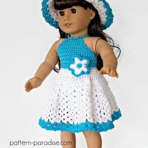 May include: A crocheted doll dress with a white skirt and a turquoise bodice. The dress has a white flower on the bodice and a turquoise trim around the skirt. The doll is wearing a white and turquoise crocheted hat and turquoise sandals.