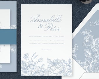 May include: A wedding invitation suite with a blue and white color scheme. The invitation features a floral design with the names "Annabelle & Peter" printed in a script font. The RSVP card has the text "Respond" printed in a bold font. The details card has the text "Details" printed in a bold font. The envelope liner features a floral design in a light blue color. The envelope is white with the text "James & Shirley Lamb" printed in a script font. The address is printed below the names. The text on the envelope reads "275 Lake Forest Drive, Harrison, NY 10528".