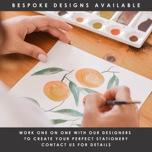 May include: A hand paints a watercolor illustration of oranges on a branch with green leaves. The text "BESPOKE DESIGNS AVAILABLE" is at the top of the image. The text "WORK ONE ON ONE WITH OUR DESIGNERS TO CREATE YOUR PERFECT STATIONERY CONTACT US FOR DETAILS" is at the bottom of the image.