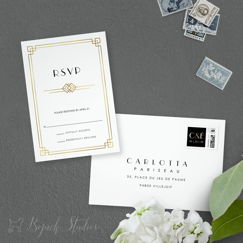 May include: Gold framed RSVP card with a gold geometric design. The text "RSVP" is in a bold, sans-serif font. The card includes a line for the guest's name and two options for responding: "Joyfully Accepts" and "Regretfully Declines". The card also includes the text "Please respond by April 21".