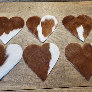 6 heart-shaped cowhide coasters, brown/white spotted, approx. 12.5 cm x 13 cm