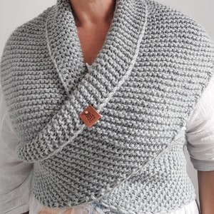 May include: A gray knitted cowl with a leather tag that says "Made with Love".