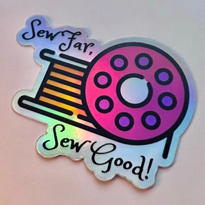 May include: A holographic sticker with a pink and purple spool of thread and the text "Sew far, Sew good!"