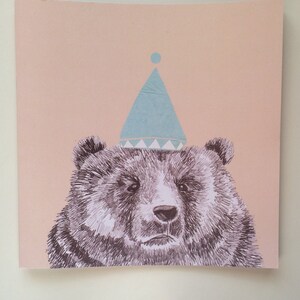 May include: A black and white illustration of a bear wearing a light blue party hat with a white trim. The background is a light pink color.