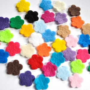 May include: Assortment of felt flower shapes in various colors, including red, blue, green, yellow, pink, purple, orange, brown, black, and white.