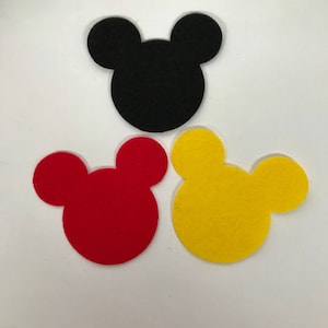 May include: Three felt Mickey Mouse head shapes in black, red, and yellow.
