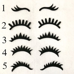 May include: Five different styles of black felt eyelashes, numbered 1 through 5. Each style has a different shape and length of lashes.