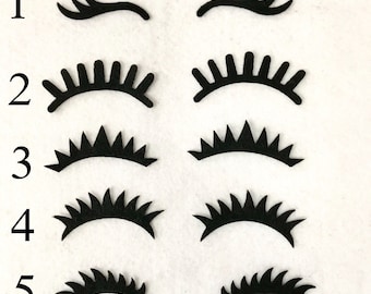 May include: Five different styles of black felt eyelashes, numbered 1 through 5. Each style has a different shape and length of lashes.