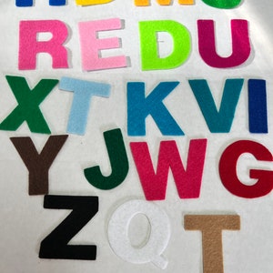 May include: Felt letters in various colors, including blue, yellow, orange, green, pink, red, and brown. The letters are arranged in alphabetical order, starting with H and ending with T.