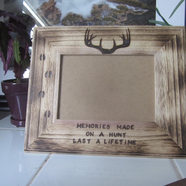 Memories made on a hunt last a lifetime 11X9 frame fits 5X7 picture. Hand woodburned tracks antlers and quote.