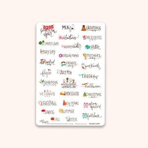 May include: A white sticker sheet featuring handwritten holiday-themed text. Includes phrases like "Happy New Year," "Valentine's," "St. Patrick's Day," "Mother's Day," and "Christmas." The sticker sheet is perfect for planners and scrapbooking.