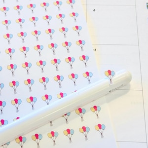 May include: A sheet of stickers with a repeating pattern of three balloons in pink, yellow, and blue. The balloons are tied together with a string. The stickers are on a white background.