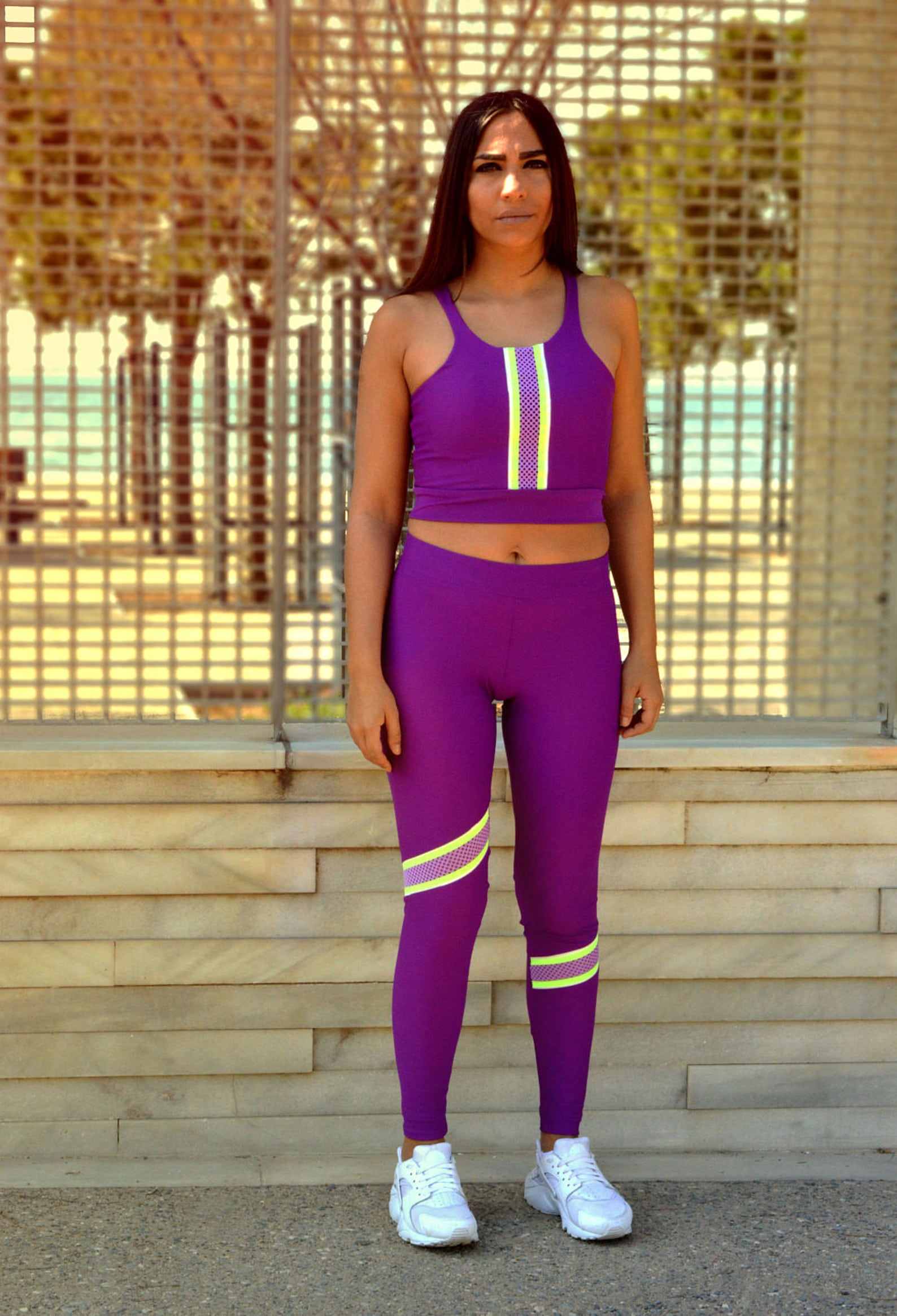 Purple Workout Leggings and Adidas Top tying shoes - Putting Me Together
