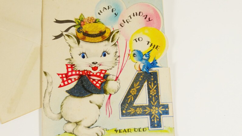 May include: A white cat wearing a blue jacket and a red and white checkered bow tie holds balloons that say "Happy Birthday to the 4 Year Old". A blue bird sits on the number 4.