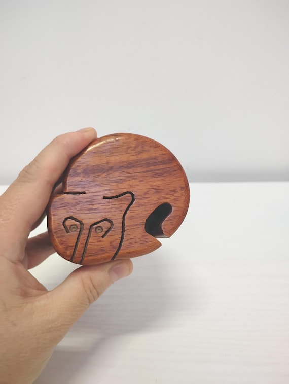 A hand-carved Sheesham wood cat puzzle box with a hidden secret compartment — solving the puzzle IS the gift experience.