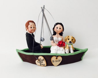 Personalised bride and groom on a boat fishing with dog wedding cake topper