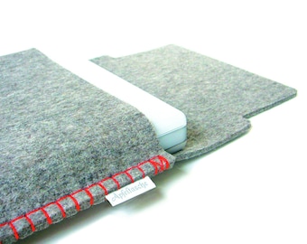 May include: Gray felt laptop sleeve with red stitching and a white label that says "Apfelnasche".