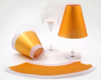 POETRY LIGHT · 3 golden lampshades for wine glasses with tea lights · made of transparent paper that can be put together