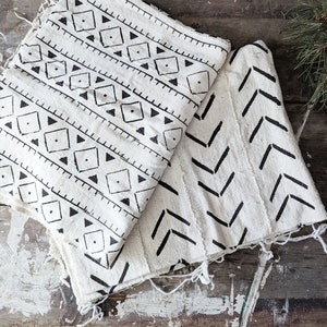 white thick cotton fabric with hand printed black slashes or geometric triangles