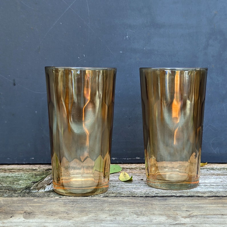 iridescent yellow vintage tall boy glasses with a thumbprint indented pattern throughout.  color ranges from yellow to gold with it's unique finish.