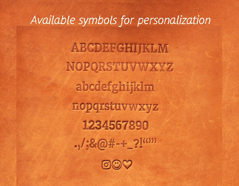 May include: Close-up of a brown leather surface with embossed letters, numbers, and symbols. The text "Available symbols for personalization" is at the top. Includes uppercase and lowercase alphabets, numbers 0-9, and various symbols.