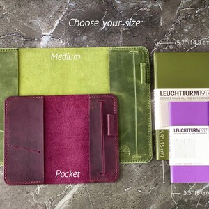 May include: Three leather notebook covers in different sizes:  "Medium", "Pocket", and a larger cover with the text "LEUCHTTURM1917" and "DETAILS MAKE ALL THE DIFFERENCE". The covers are green, burgundy, and olive green.