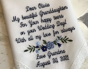 May include: White embroidered handkerchief with blue and green floral design. The text reads "Dear Olivia, My beautiful Granddaughter, For your happy tears on your Wedding Day! With all my love for always, Love Grandma, August 20, 2021".